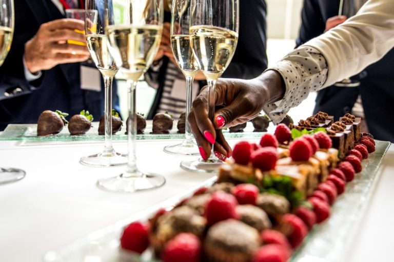 Close up of sweet treats and champagne glasses at corporate event