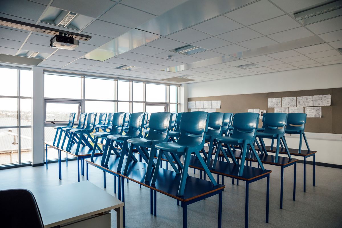 classroom with chairs on desks to enable cleaning