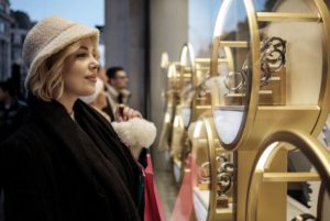 young woman looks into luxury store window