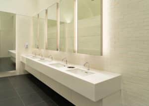 Row of white modern marble ceramic wash basin in public toilet, restroom in restaurant or hotel or shopping mall, interior decoration design