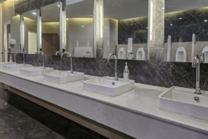 clean luxury public washroom with marble , glass and chrome