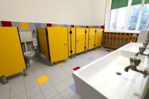 clean school washroom with sinks and cubicles