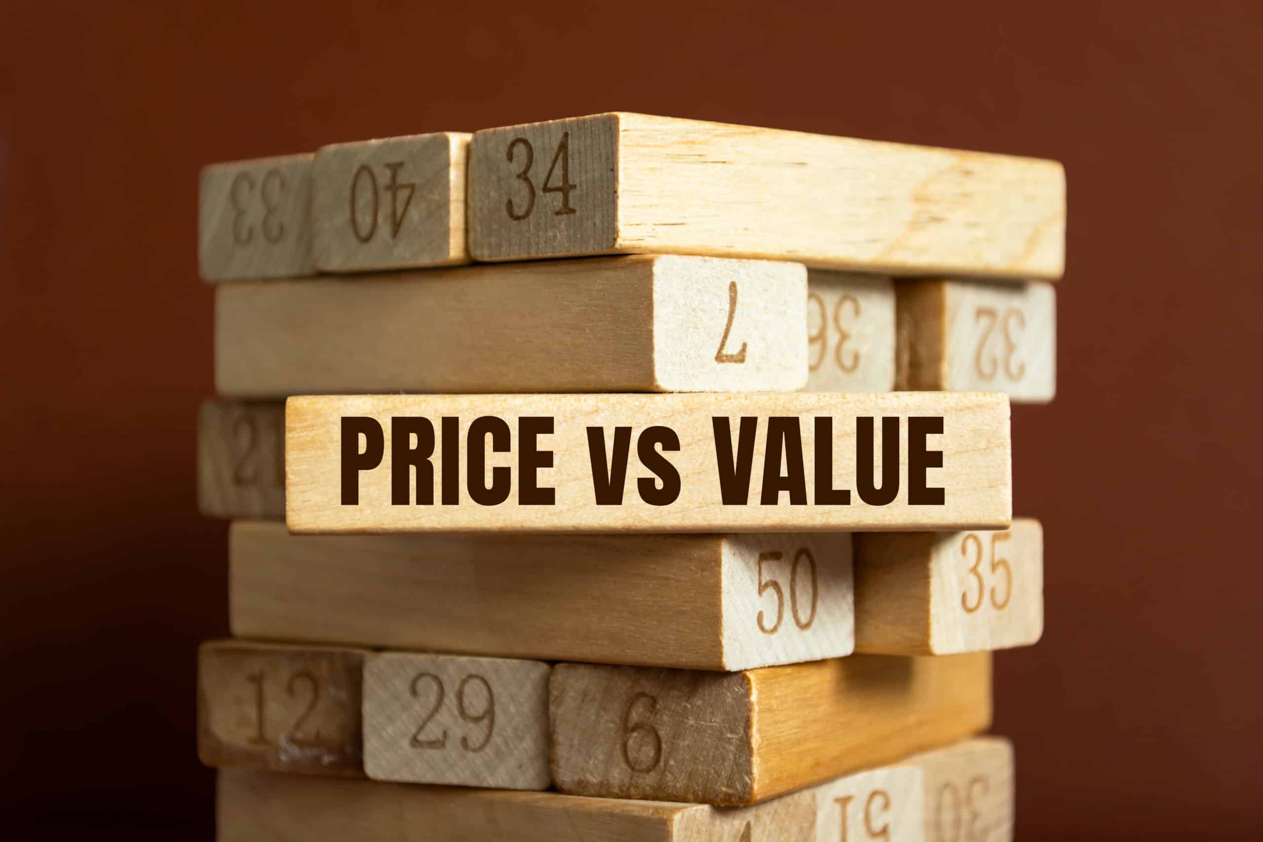 Jenga tower with a piece that is partly removed which says price vs value